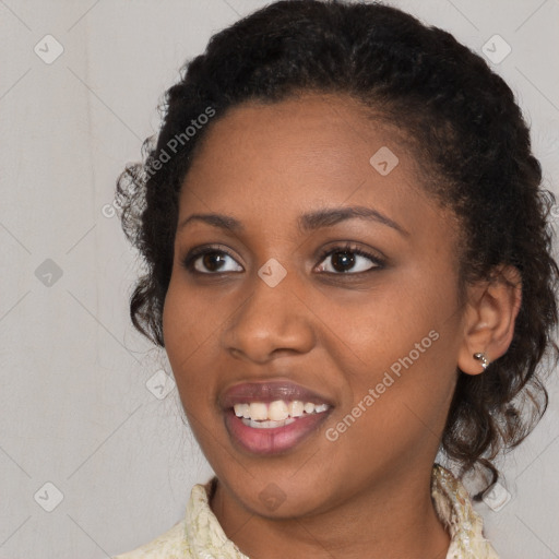 Joyful black young-adult female with medium  brown hair and brown eyes