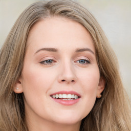 Joyful white young-adult female with long  brown hair and blue eyes