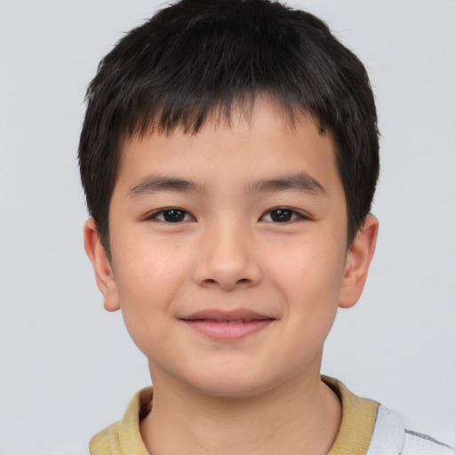 Joyful asian child male with short  brown hair and brown eyes