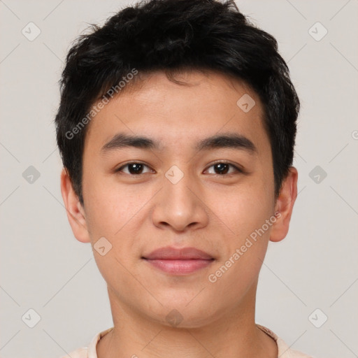 Joyful asian young-adult male with short  brown hair and brown eyes