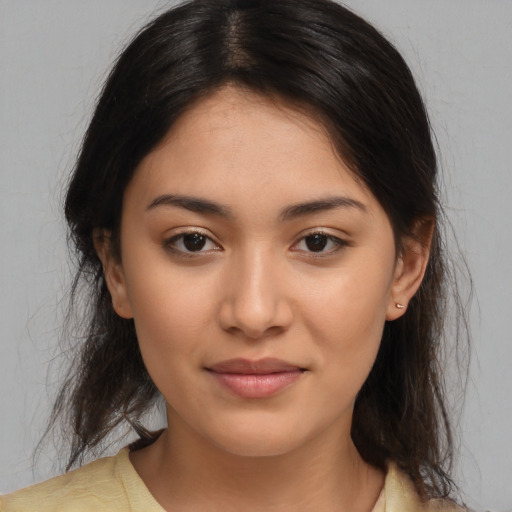 Joyful latino young-adult female with medium  brown hair and brown eyes