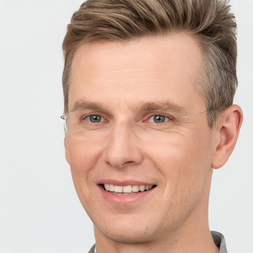 Joyful white adult male with short  brown hair and brown eyes