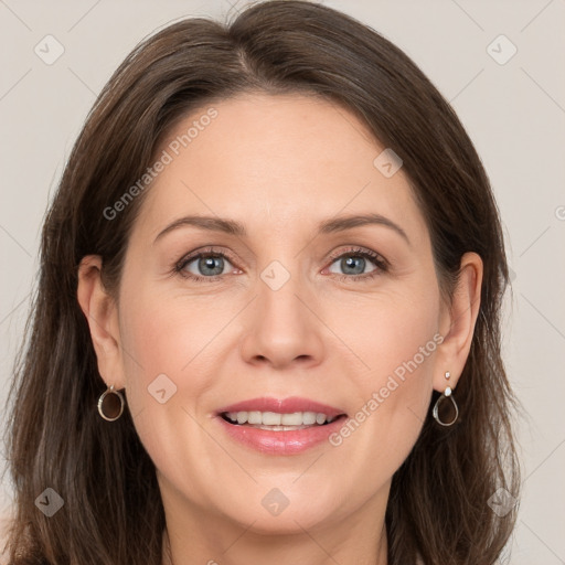 Joyful white adult female with long  brown hair and grey eyes