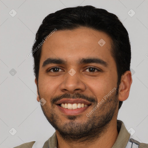 Joyful latino young-adult male with short  black hair and brown eyes