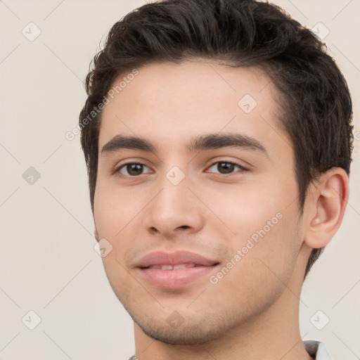 Joyful white young-adult male with short  black hair and brown eyes