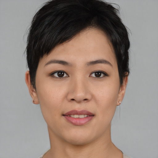 Joyful asian young-adult female with short  black hair and brown eyes