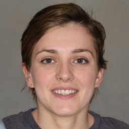 Joyful white young-adult female with medium  brown hair and blue eyes