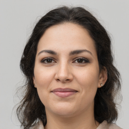 Joyful latino young-adult female with medium  brown hair and brown eyes