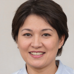 Joyful white adult female with medium  brown hair and brown eyes