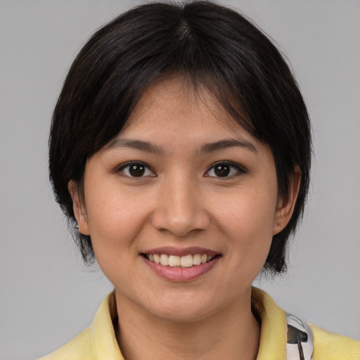 Joyful white young-adult female with medium  brown hair and brown eyes