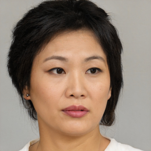 Neutral asian young-adult female with medium  brown hair and brown eyes