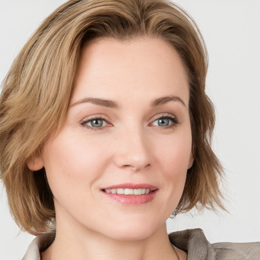 Joyful white young-adult female with medium  brown hair and blue eyes