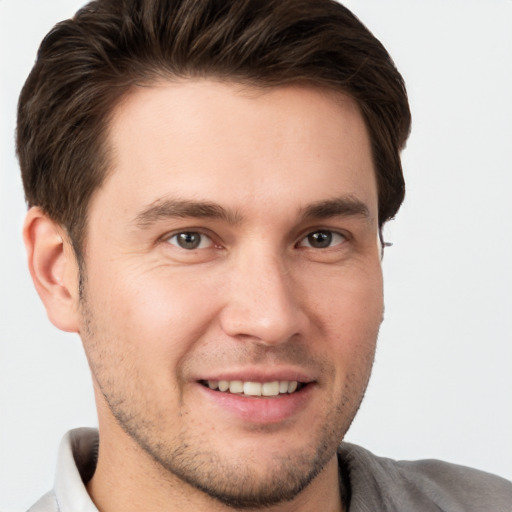 Joyful white young-adult male with short  brown hair and brown eyes