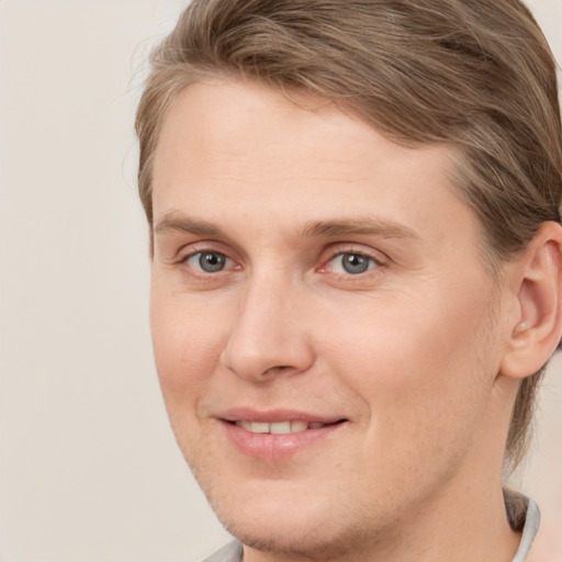 Joyful white young-adult male with medium  brown hair and brown eyes