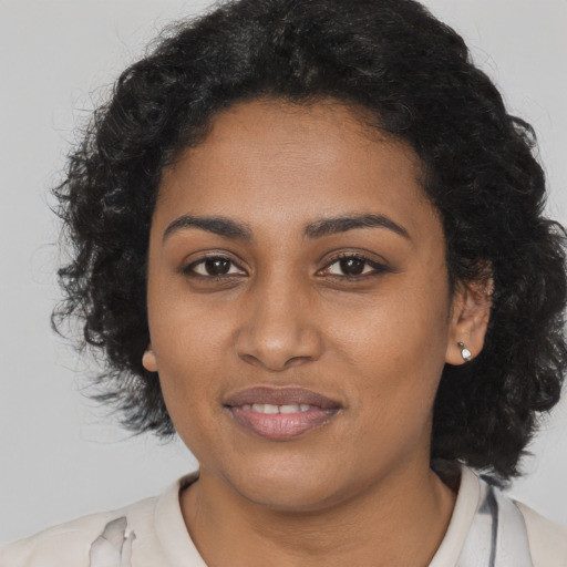 Joyful black young-adult female with medium  brown hair and brown eyes