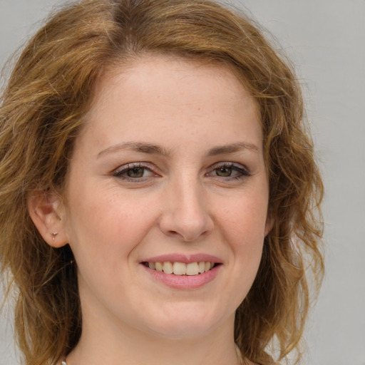 Joyful white young-adult female with medium  brown hair and blue eyes