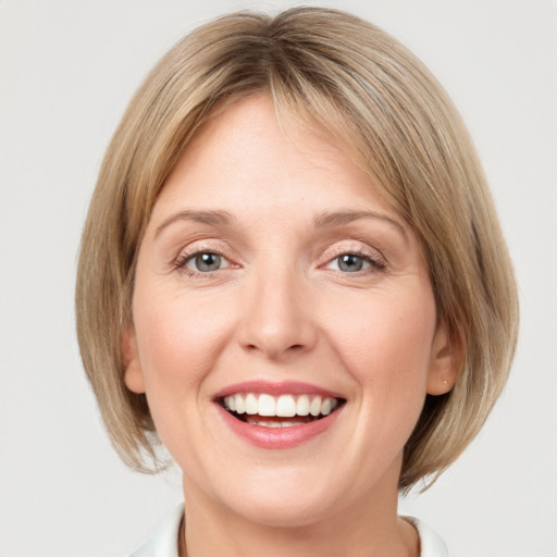 Joyful white young-adult female with medium  brown hair and blue eyes