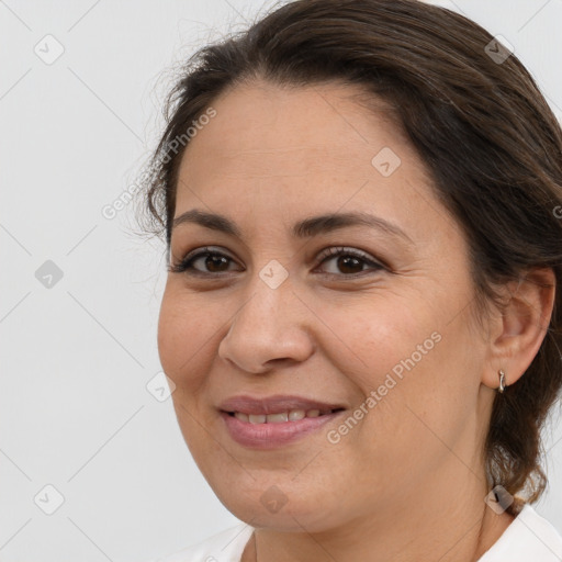 Joyful white adult female with medium  brown hair and brown eyes