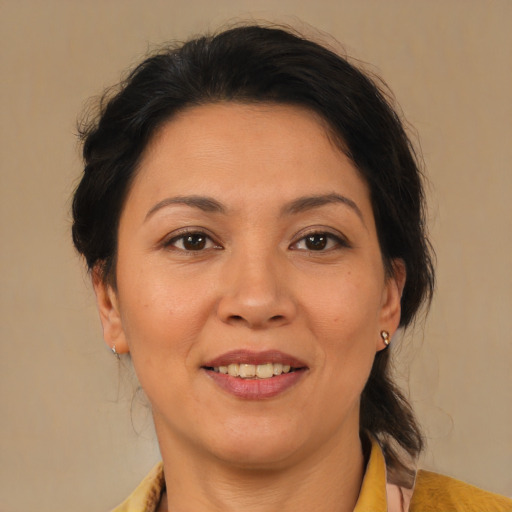 Joyful latino adult female with medium  brown hair and brown eyes