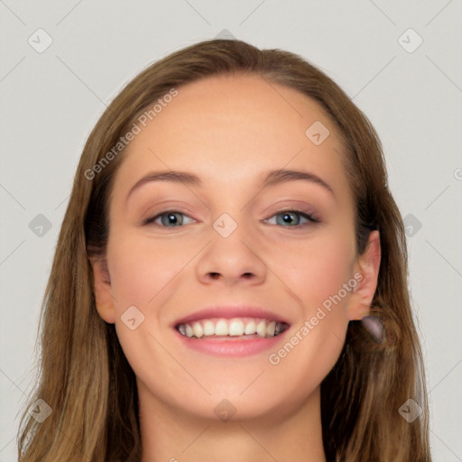 Joyful white young-adult female with long  brown hair and blue eyes