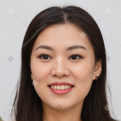 Joyful asian young-adult female with long  brown hair and brown eyes