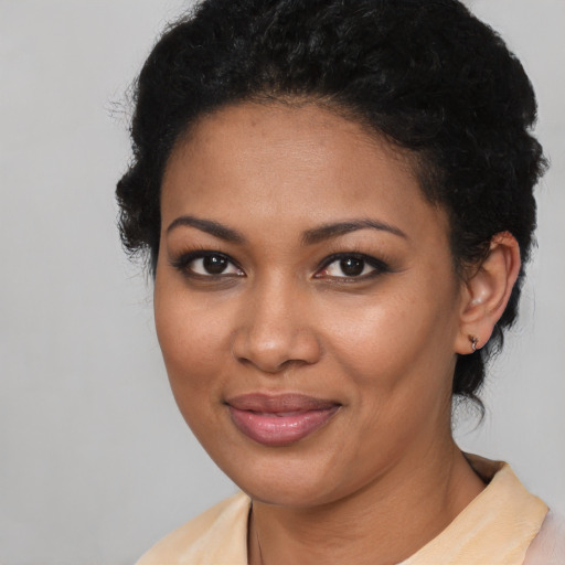 Joyful black young-adult female with medium  black hair and brown eyes