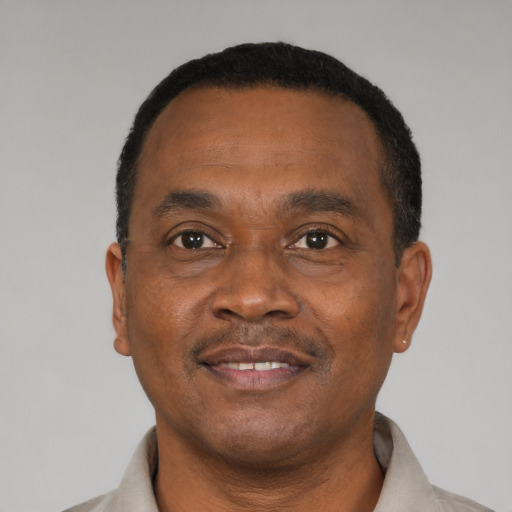 Joyful black young-adult male with short  brown hair and brown eyes