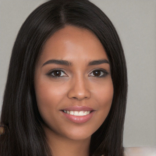 Joyful white young-adult female with long  black hair and brown eyes