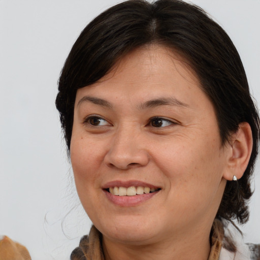 Joyful white adult female with medium  brown hair and brown eyes