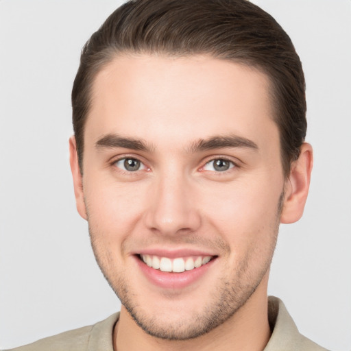 Joyful white young-adult male with short  brown hair and brown eyes