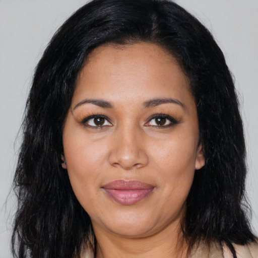 Joyful latino young-adult female with long  black hair and brown eyes