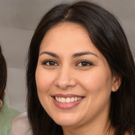 Joyful white young-adult female with medium  brown hair and brown eyes