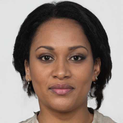 Joyful black young-adult female with medium  black hair and brown eyes
