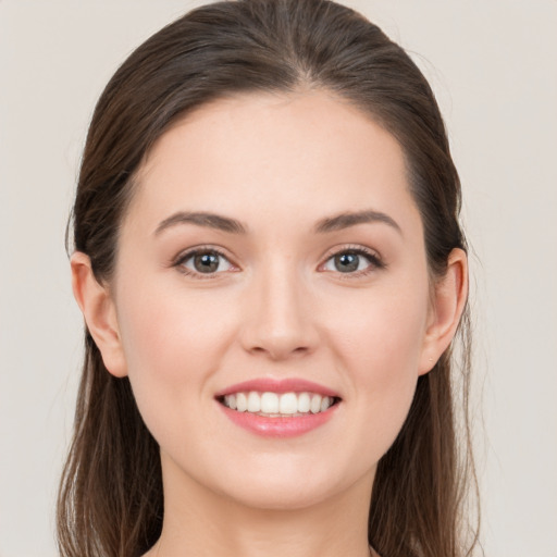 Joyful white young-adult female with long  brown hair and grey eyes