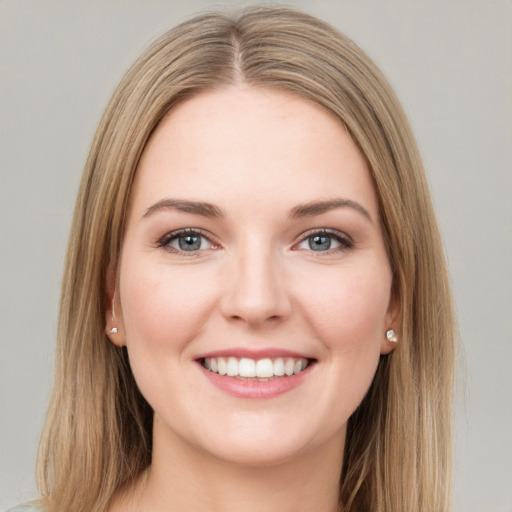 Joyful white young-adult female with long  brown hair and green eyes