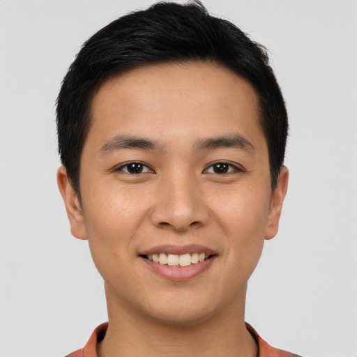 Joyful asian young-adult male with short  brown hair and brown eyes
