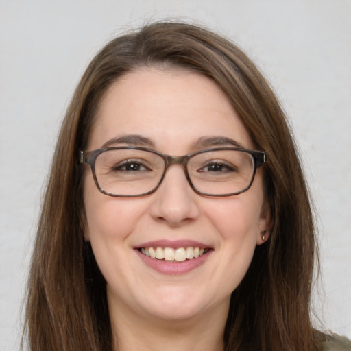 Joyful white young-adult female with long  brown hair and green eyes