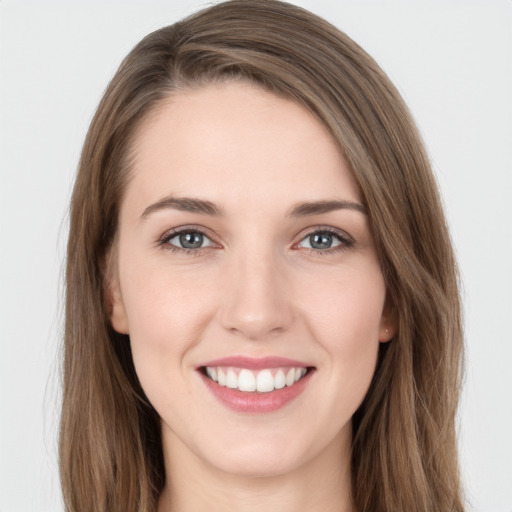 Joyful white young-adult female with long  brown hair and grey eyes