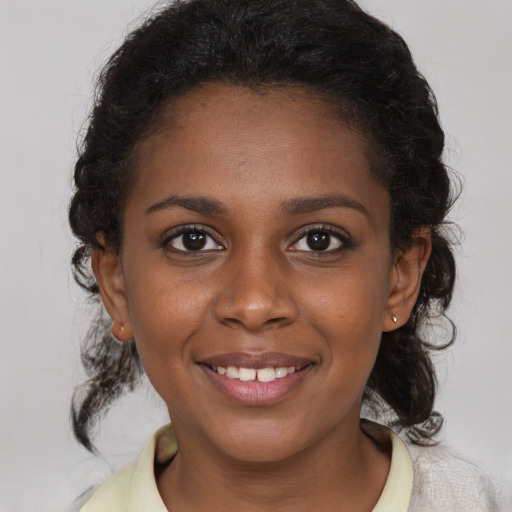 Joyful black young-adult female with medium  brown hair and brown eyes