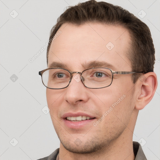 Joyful white young-adult male with short  brown hair and grey eyes