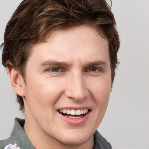 Joyful white adult male with short  brown hair and grey eyes