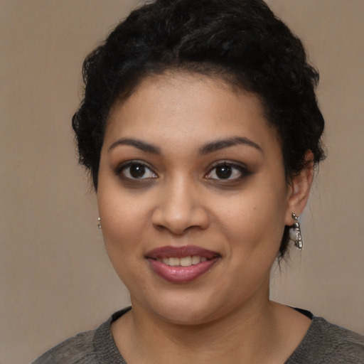 Joyful latino young-adult female with short  black hair and brown eyes