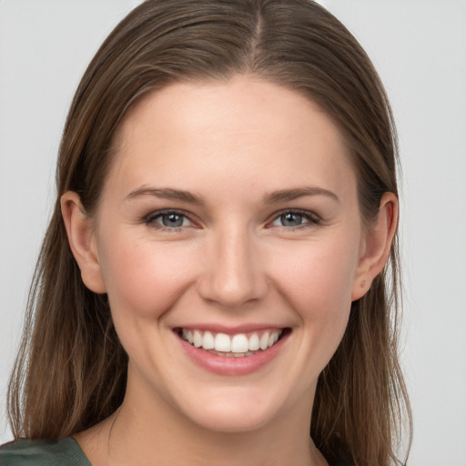 Joyful white young-adult female with long  brown hair and grey eyes