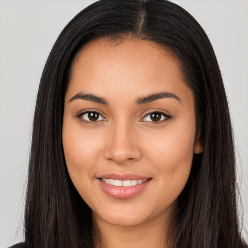 Joyful latino young-adult female with long  brown hair and brown eyes