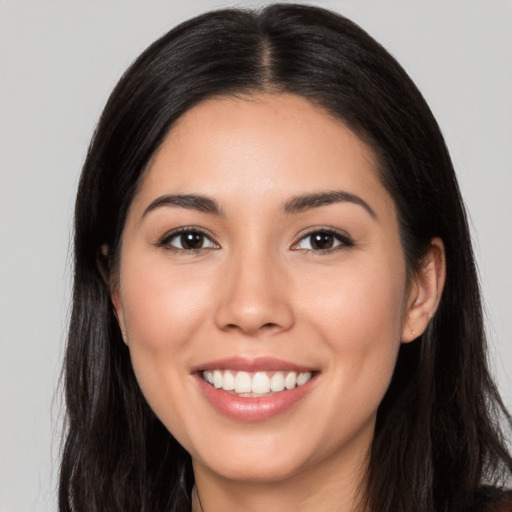 Joyful white young-adult female with long  black hair and brown eyes