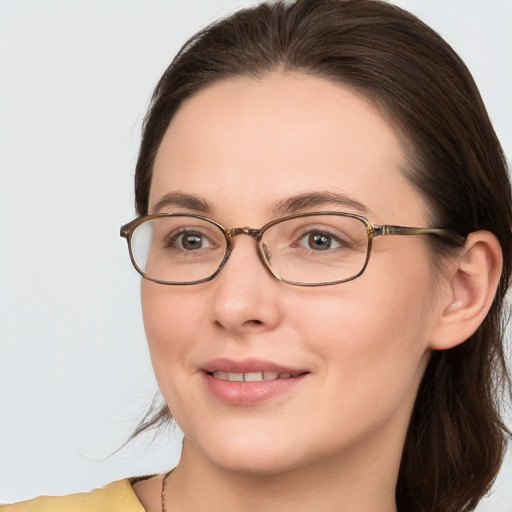 Joyful white young-adult female with long  brown hair and blue eyes