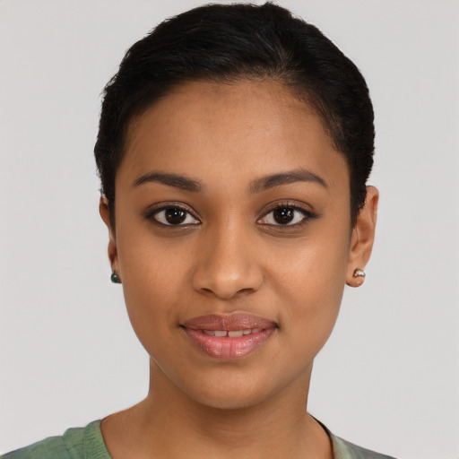 Joyful latino young-adult female with short  black hair and brown eyes