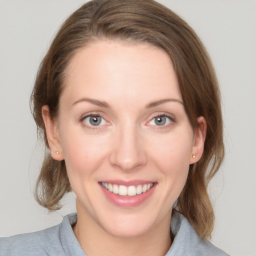 Joyful white young-adult female with medium  brown hair and blue eyes