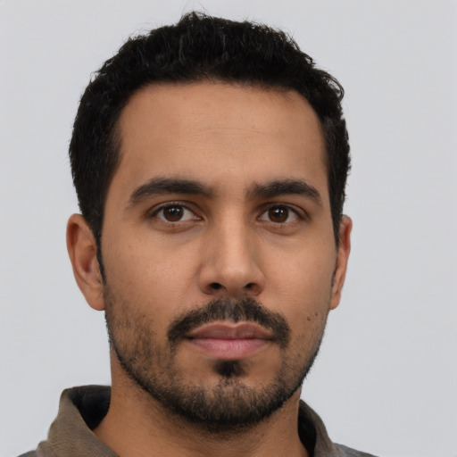 Neutral latino young-adult male with short  black hair and brown eyes