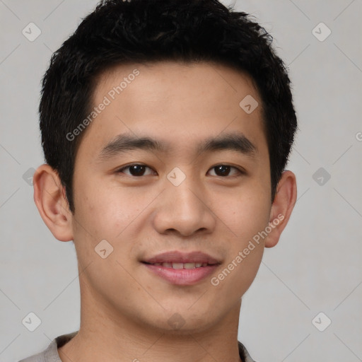 Joyful asian young-adult male with short  black hair and brown eyes